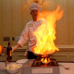 Homewood Alabama chef cooking in front of flaming pan