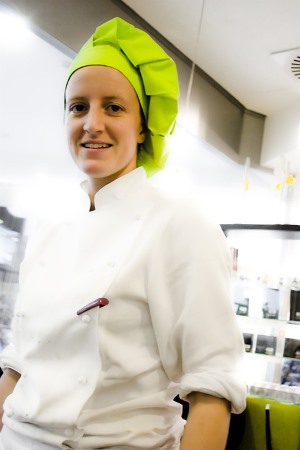 Badger Alaska woman chef wearing green chef hat